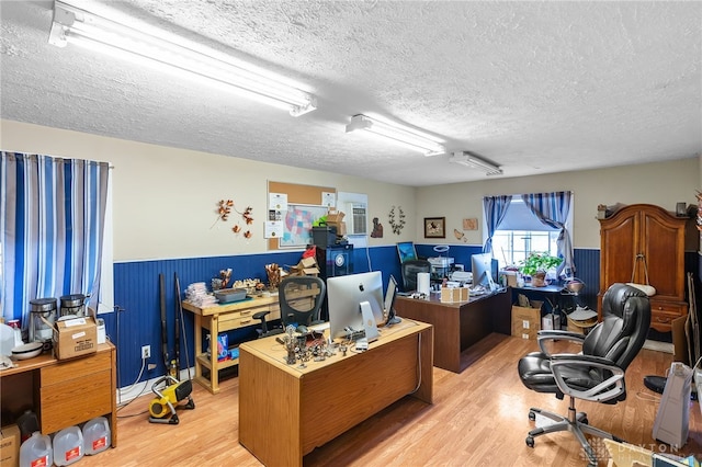 6384 Heffner Rd, Tipp City, OH 45371 - office featuring light wood-style flooring, a textured ceiling, and a wainscoted wall