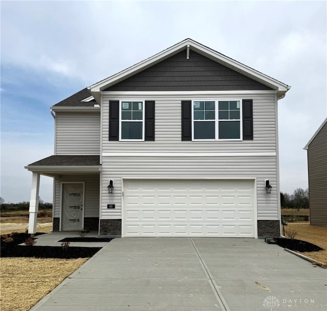traditional home with an attached garage and driveway