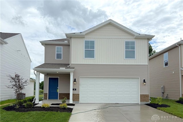 58 E Kentucky Ave, Wilmington, OH 45177 - view of front facade with a garage, driveway, and stone siding