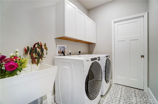 1002 Belfast Dr, Sugarcreek Township, OH 45440 - laundry room featuring a sink, washing machine and dryer, cabinet space, light tile patterned flooring, and baseboards