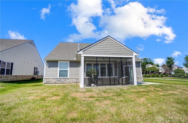 1002 Belfast Dr, Sugarcreek Township, OH 45440 - rear view of house featuring stone siding, a lawn, outdoor lounge area, and a sunroom