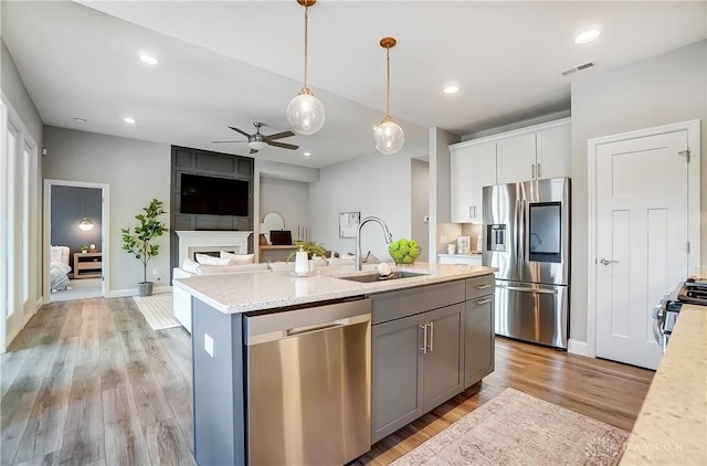 1002 Belfast Dr, Sugarcreek Township, OH 45440 - kitchen featuring visible vents, appliances with stainless steel finishes, white cabinets, a ceiling fan, and a sink