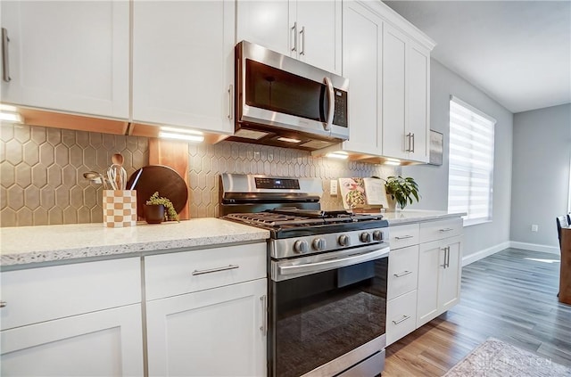 1002 Belfast Dr, Sugarcreek Township, OH 45440 - kitchen featuring tasteful backsplash, white cabinets, appliances with stainless steel finishes, and baseboards