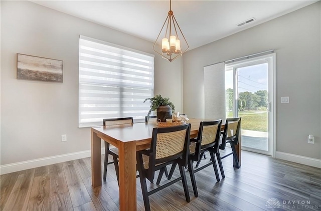1002 Belfast Dr, Sugarcreek Township, OH 45440 - dining room featuring visible vents, wood finished floors, baseboards, and a chandelier