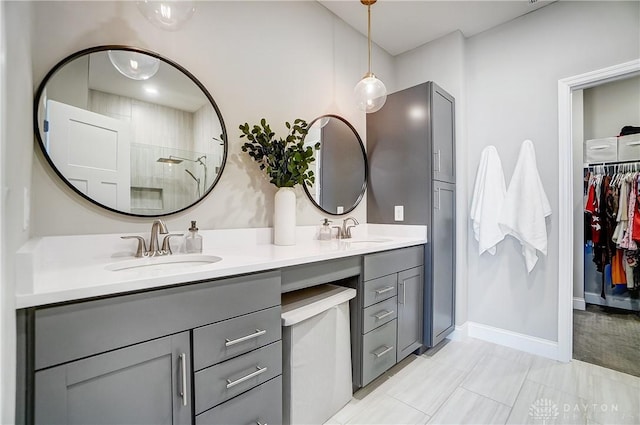 1002 Belfast Dr, Sugarcreek Township, OH 45440 - full bath featuring a walk in closet, double vanity, tiled shower, and a sink