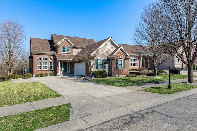 traditional-style home featuring driveway, an attached garage, a front lawn, stone siding, and brick siding