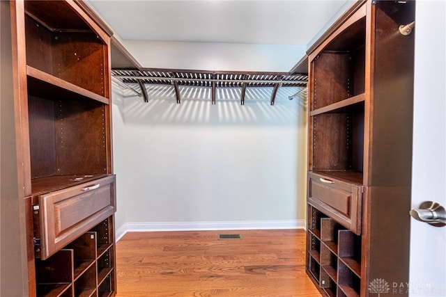 spacious closet with wood finished floors and visible vents