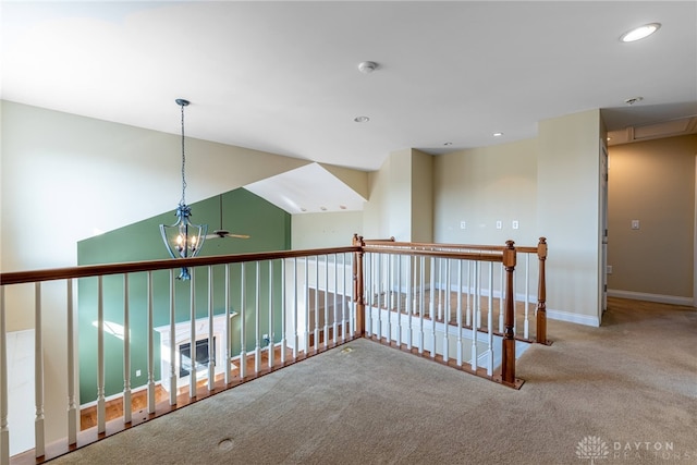 hallway featuring an upstairs landing, recessed lighting, baseboards, and carpet