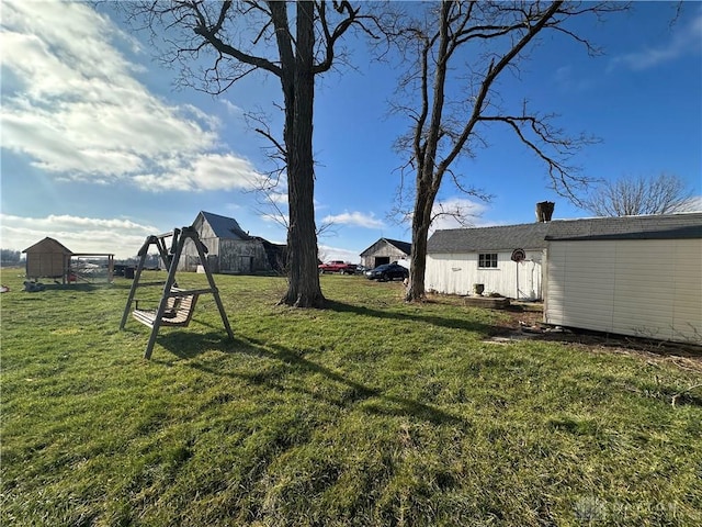 view of yard with an outbuilding and a shed