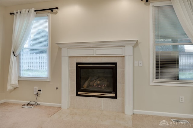 details featuring visible vents, a fireplace, baseboards, and carpet floors