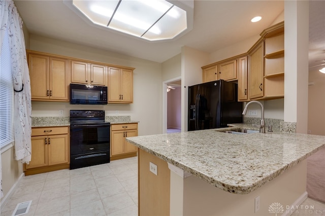 kitchen with visible vents, black appliances, a sink, open shelves, and a peninsula