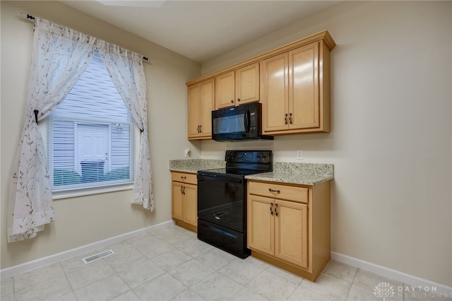 kitchen with light stone counters, light brown cabinets, baseboards, visible vents, and black appliances