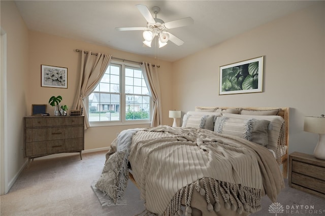 carpeted bedroom with baseboards and ceiling fan