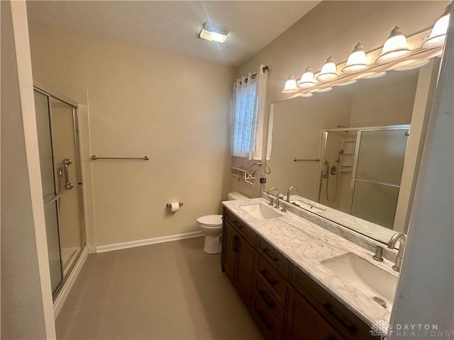 full bathroom featuring baseboards, a stall shower, and a sink