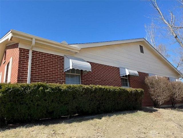 view of property exterior with brick siding