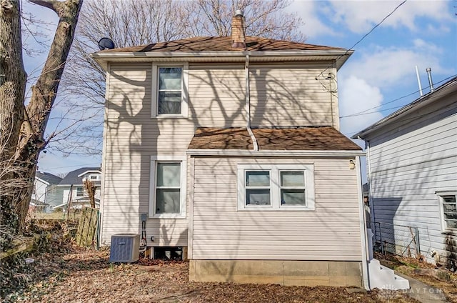 252 Illinois Ave, Dayton, OH 45410 - view of home's exterior with a chimney, central air condition unit, and a shingled roof