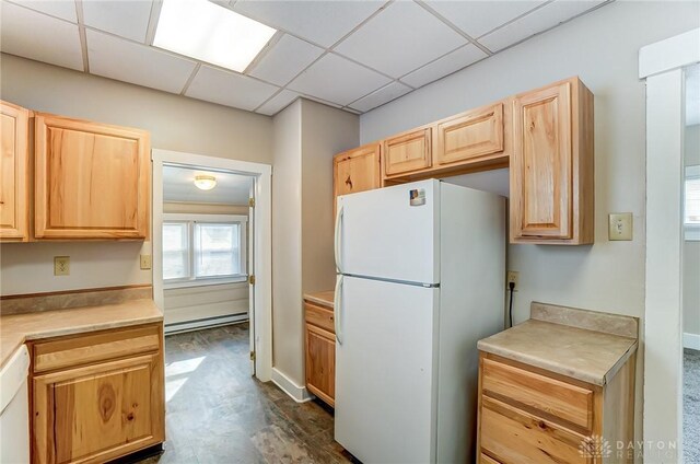 252 Illinois Ave, Dayton, OH 45410 - kitchen with freestanding refrigerator, a baseboard heating unit, light brown cabinetry, light countertops, and a paneled ceiling