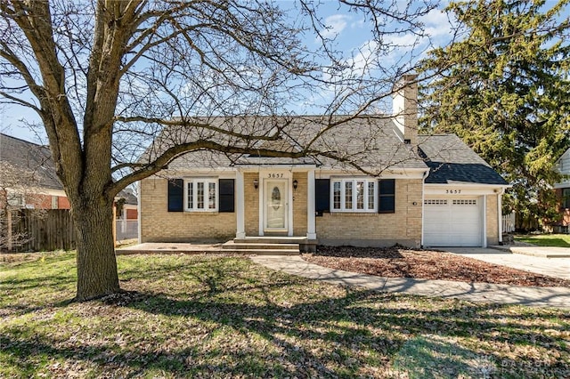 3657 Shroyer Rd, Dayton, OH 45429 - view of front facade with a garage, fence, brick siding, a chimney, and concrete driveway