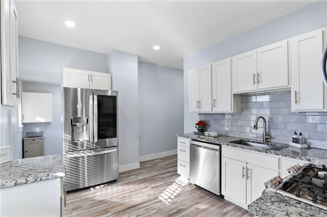 331 Morton Ave, Dayton, OH 45410 - kitchen featuring white cabinetry, backsplash, light stone countertops, stainless steel appliances, and a sink