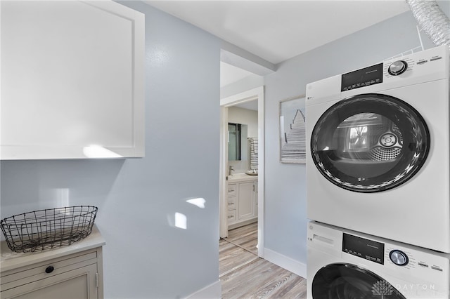 331 Morton Ave, Dayton, OH 45410 - laundry area featuring estacked washer and dryer and light wood-type flooring