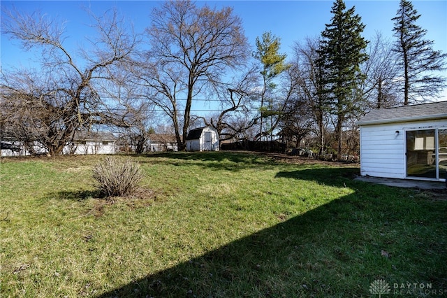 5027 Hackett Dr, Dayton, OH 45417 - view of grassy yard with an outbuilding and a shed
