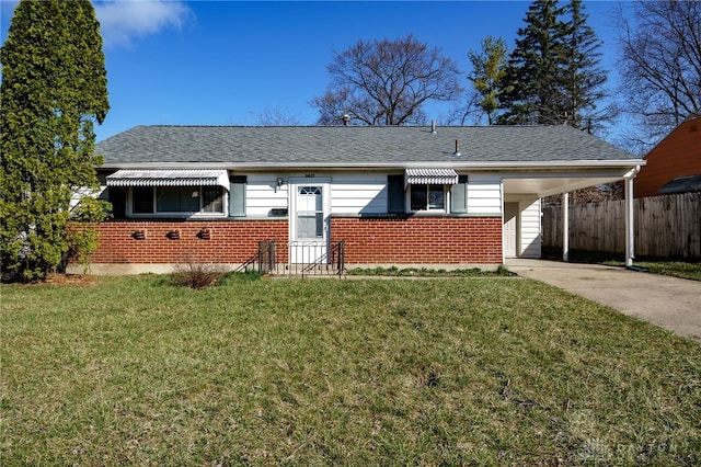 5027 Hackett Dr, Dayton, OH 45417 - view of front of property featuring brick siding, concrete driveway, an attached carport, and roof with shingles
