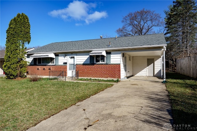 5027 Hackett Dr, Dayton, OH 45417 - view of front of home featuring brick siding, driveway, an attached carport, and a shingled roof