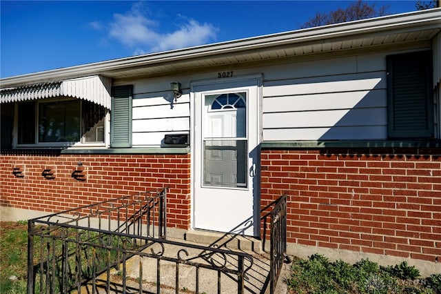 5027 Hackett Dr, Dayton, OH 45417 - doorway to property with brick siding and fence