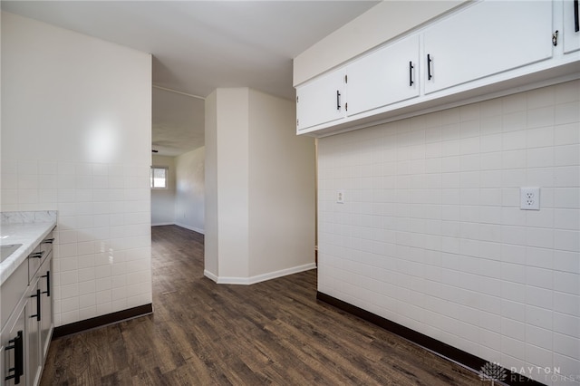 5027 Hackett Dr, Dayton, OH 45417 - kitchen featuring tile walls, dark wood-style floors, white cabinetry, baseboards, and light stone countertops