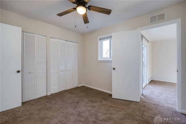 5027 Hackett Dr, Dayton, OH 45417 - unfurnished bedroom featuring carpet flooring, multiple closets, ceiling fan, and baseboards