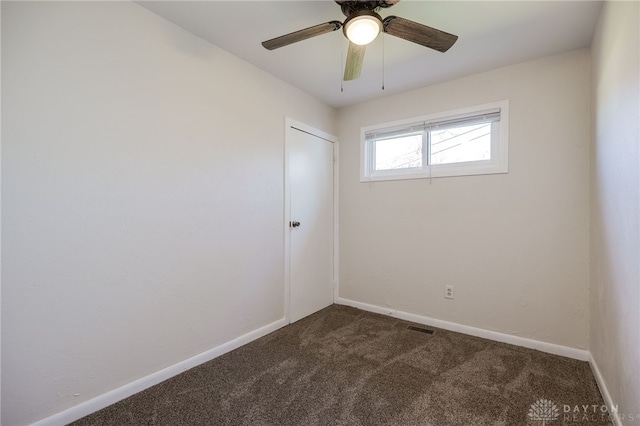 5027 Hackett Dr, Dayton, OH 45417 - spare room featuring dark colored carpet, baseboards, and ceiling fan