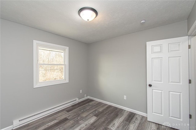 unfurnished room featuring a baseboard heating unit, baseboards, a textured ceiling, and dark wood-style flooring