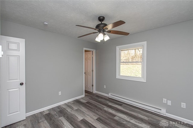 unfurnished room featuring dark wood-style floors, baseboards, ceiling fan, a textured ceiling, and baseboard heating