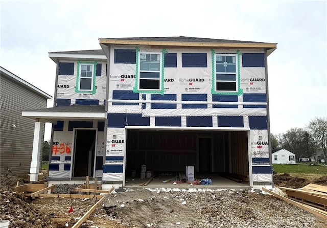 property in mid-construction with an attached garage and driveway