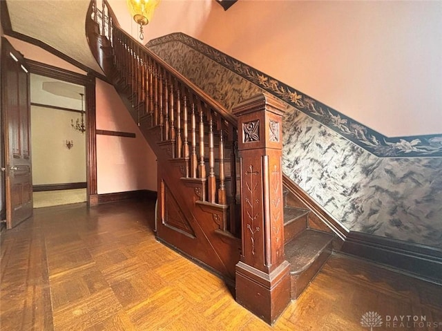 stairway featuring wallpapered walls and baseboards