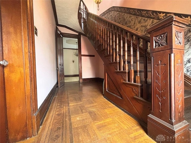 staircase featuring baseboards