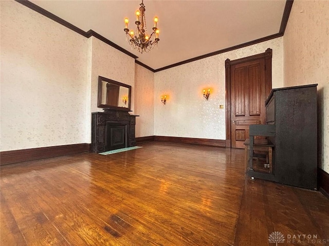 unfurnished living room with wallpapered walls, baseboards, a chandelier, hardwood / wood-style floors, and a fireplace
