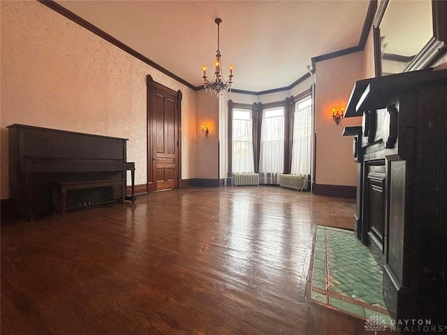 living room featuring ornamental molding, wood finished floors, radiator heating unit, an inviting chandelier, and baseboards