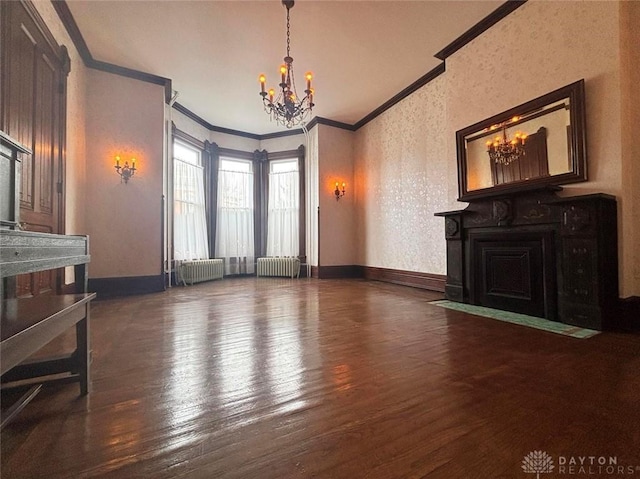 living area featuring a notable chandelier, radiator heating unit, and ornamental molding