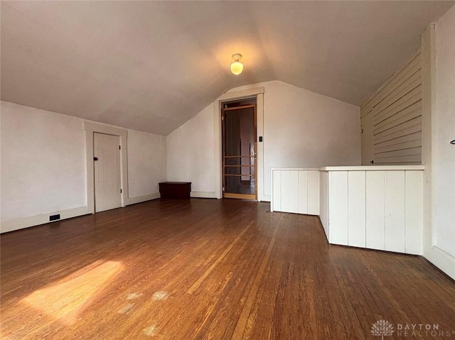 bonus room with lofted ceiling and wood finished floors