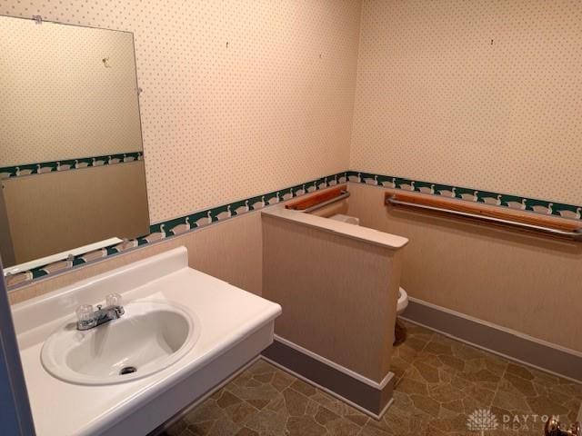 2 County Line Rd, College Corner, OH 45003 - half bath featuring toilet, wallpapered walls, baseboards, and a sink
