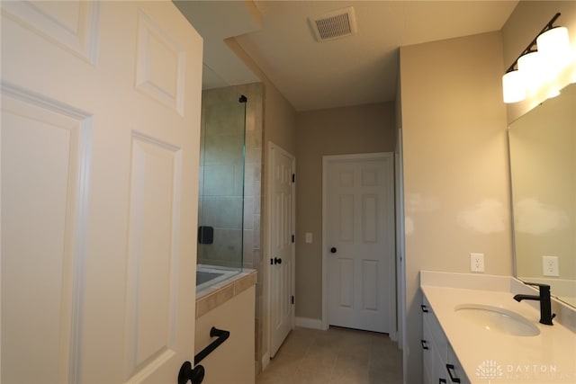 2855 Sky Crossing Dr Unit 50, Beavercreek, OH 45434 - bathroom with tile patterned floors, vanity, and tiled shower