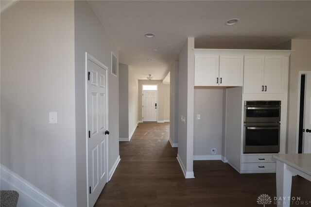 2855 Sky Crossing Dr Unit 50, Beavercreek, OH 45434 - kitchen with double oven, dark wood-style flooring, white cabinetry, recessed lighting, and light countertops