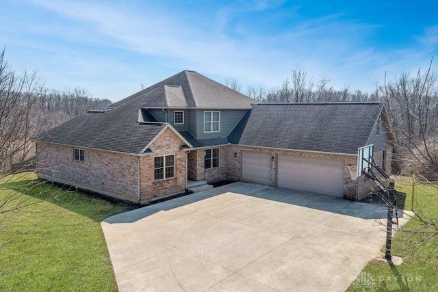 view of front of property with roof with shingles, concrete driveway, a front yard, a garage, and brick siding