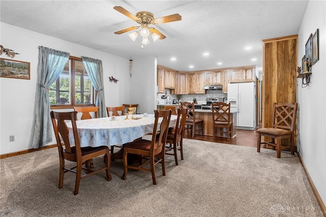 carpeted dining area with a ceiling fan, baseboards, and recessed lighting