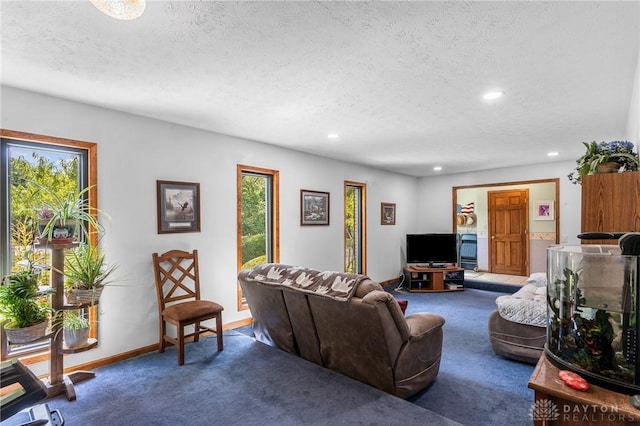carpeted living room featuring recessed lighting, a textured ceiling, and a wealth of natural light