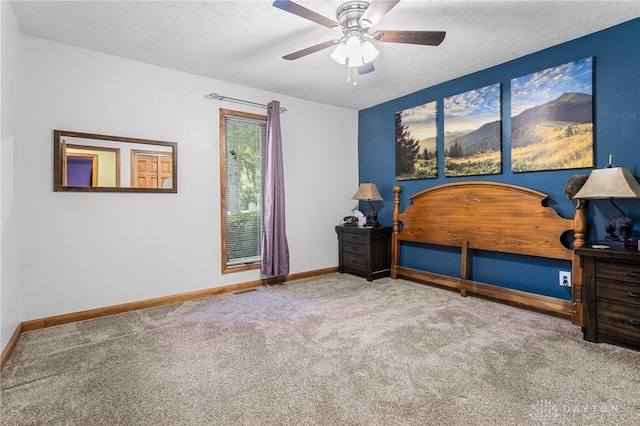 carpeted bedroom with baseboards, ceiling fan, and a textured ceiling