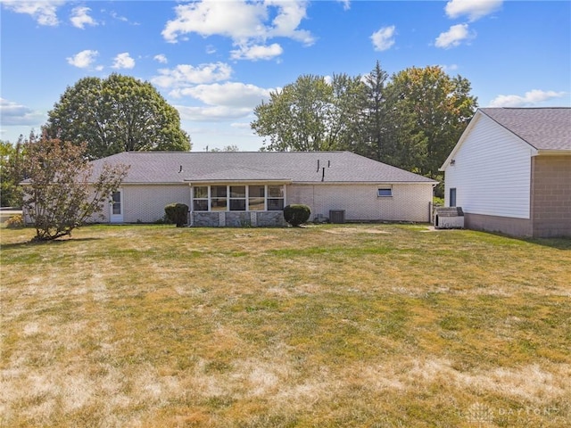 back of property featuring a sunroom and a yard