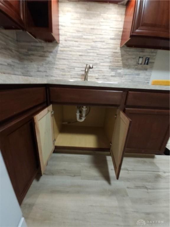 kitchen featuring tasteful backsplash and a sink