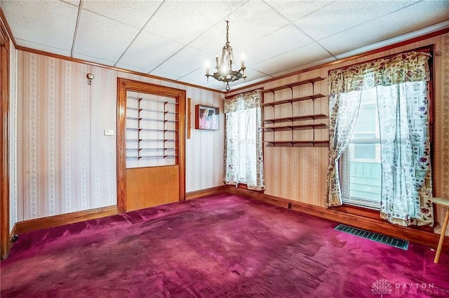 322 Hickory St, Dayton, OH 45410 - unfurnished dining area with visible vents, carpet floors, wallpapered walls, a drop ceiling, and a notable chandelier